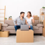 A couple that has just moved, thinking about where to put furniture