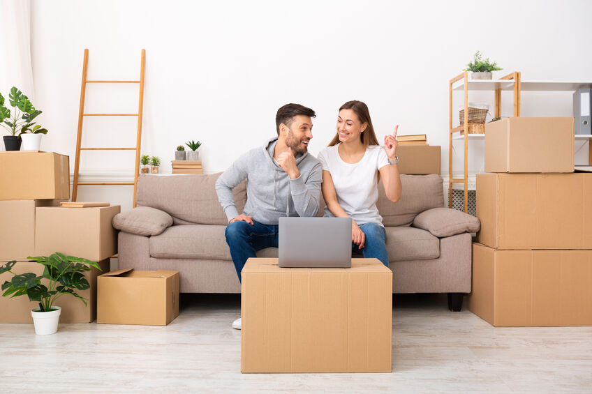 A couple that has just moved, thinking about where to put furniture