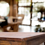 Selected focus empty brown wooden table and Coffee shop blur background with bokeh image. for your photomontage or product display.