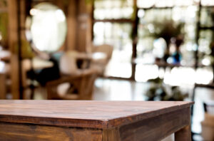 Selected focus empty brown wooden table and Coffee shop blur background with bokeh image. for your photomontage or product display.